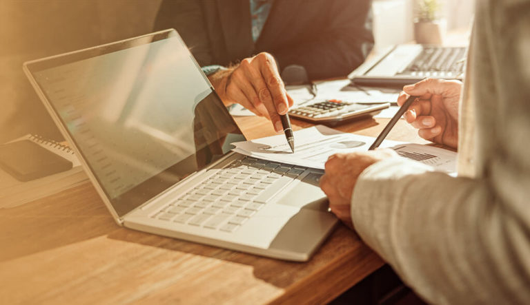 Two people review charts evaluating a lottery annuity