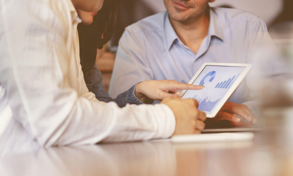 A couple meeting with a salesperson to learn about selling their lottery annuity for a lump sum